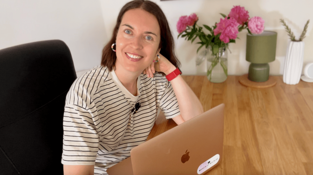 Aga Murdoch sitting at her desk with her laptop